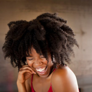 Woman with big natural hair laughing