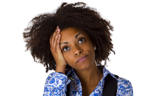 Natural hair woman holding head looking worried