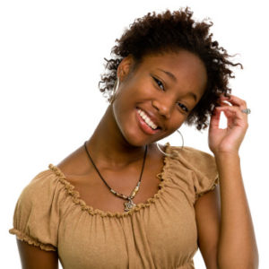 Woman touching her short natural hair smiling