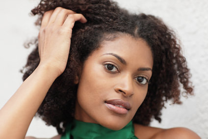 Woman with hand in her natural curly hair