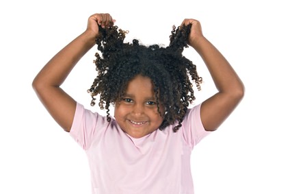 Young black girl pulling on her curly hair