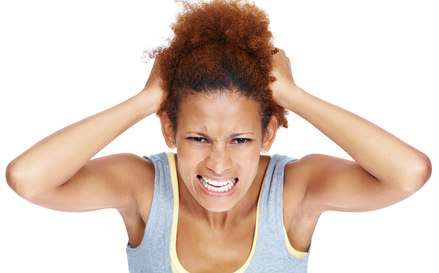 Very frustrated and angry woman pulling her natural hair
