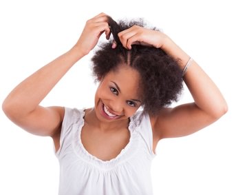 Woman braiding her kinky afro hair