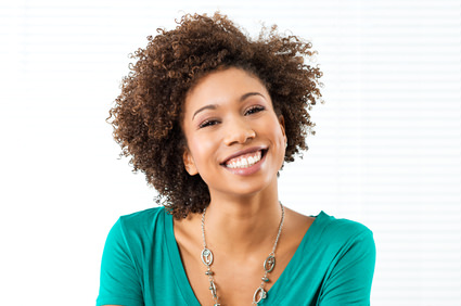 Woman with kinky curly 4a hair smiling