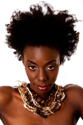 Woman with kinky natural hair and heavy ethnic necklace