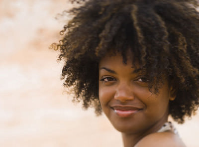 Woman with kinky curly natural hair smiling