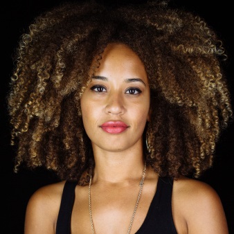 Lady with big curly natural hair and highlights