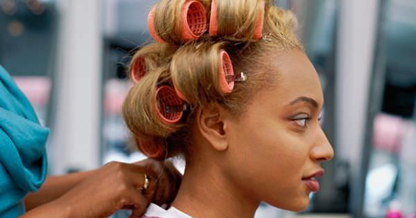 Side profile of a young woman wearing curlers