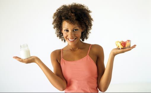 woman holding milk and fruit